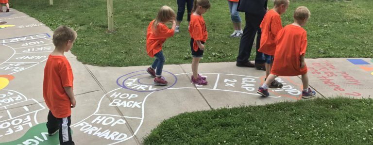 kids playing hopscotch on the Born Learning Trail